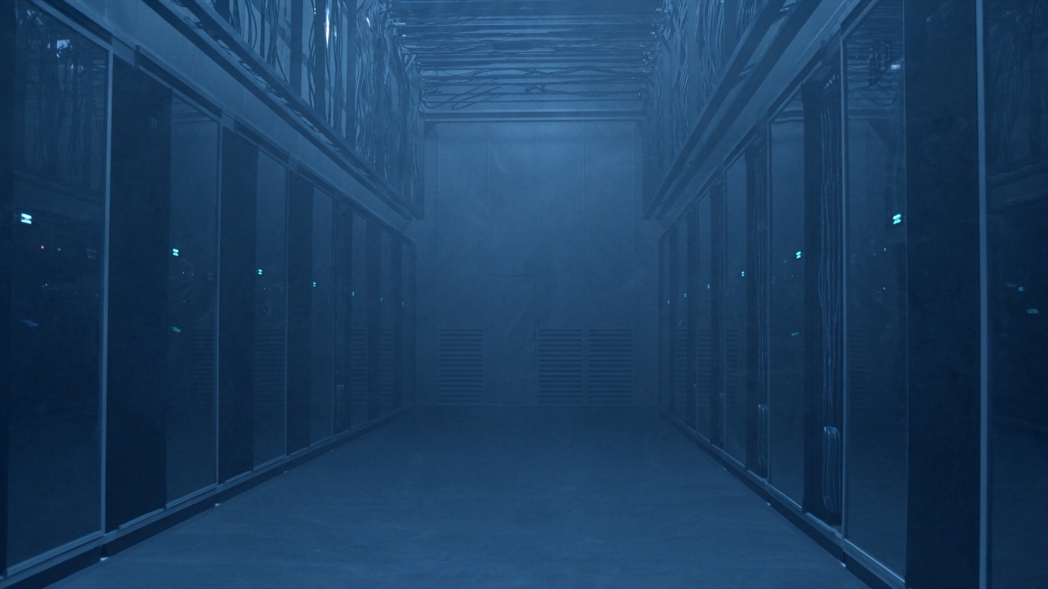 Illustrative view: cold aisle between server racks inside a modern data centre hall
