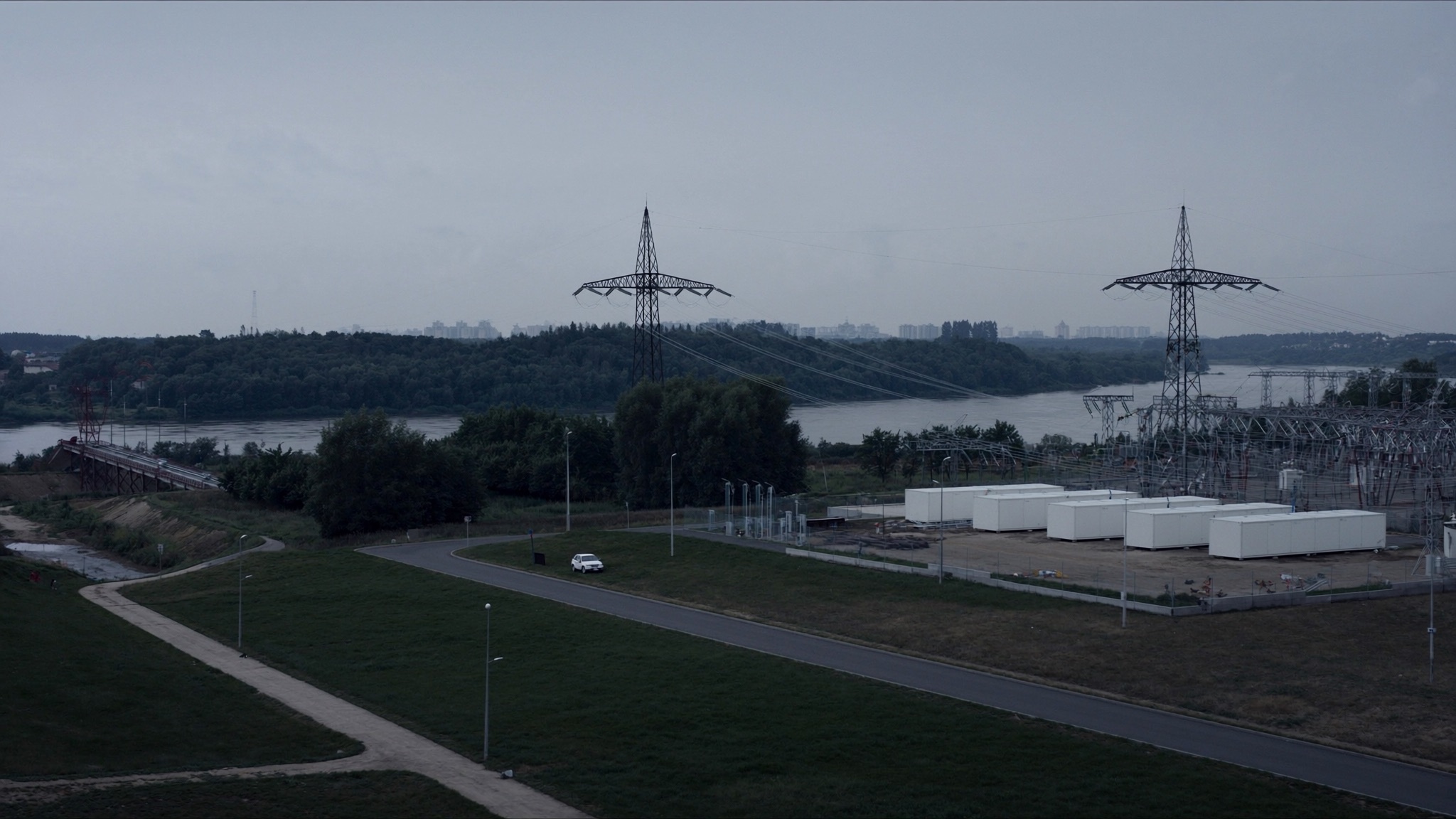 Illustrative view: battery storage containers beside a 330 kV substation near the Daugava river outside Rīga